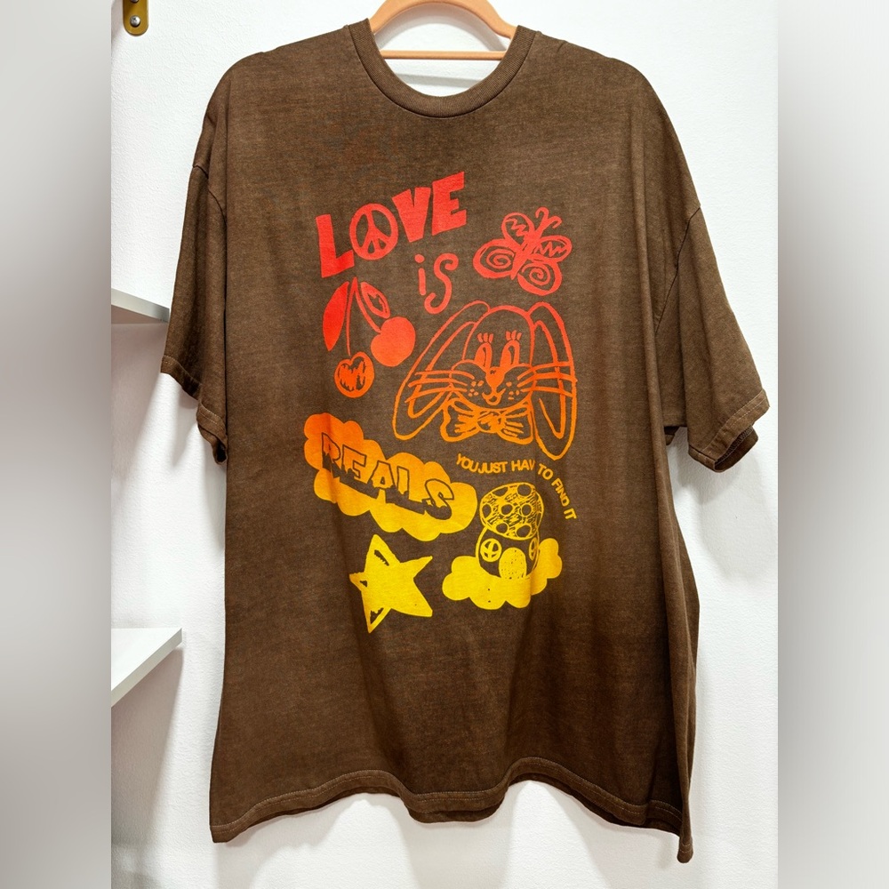 Brown oversized Urban Outfitters Tshirt with peace themed logos on front